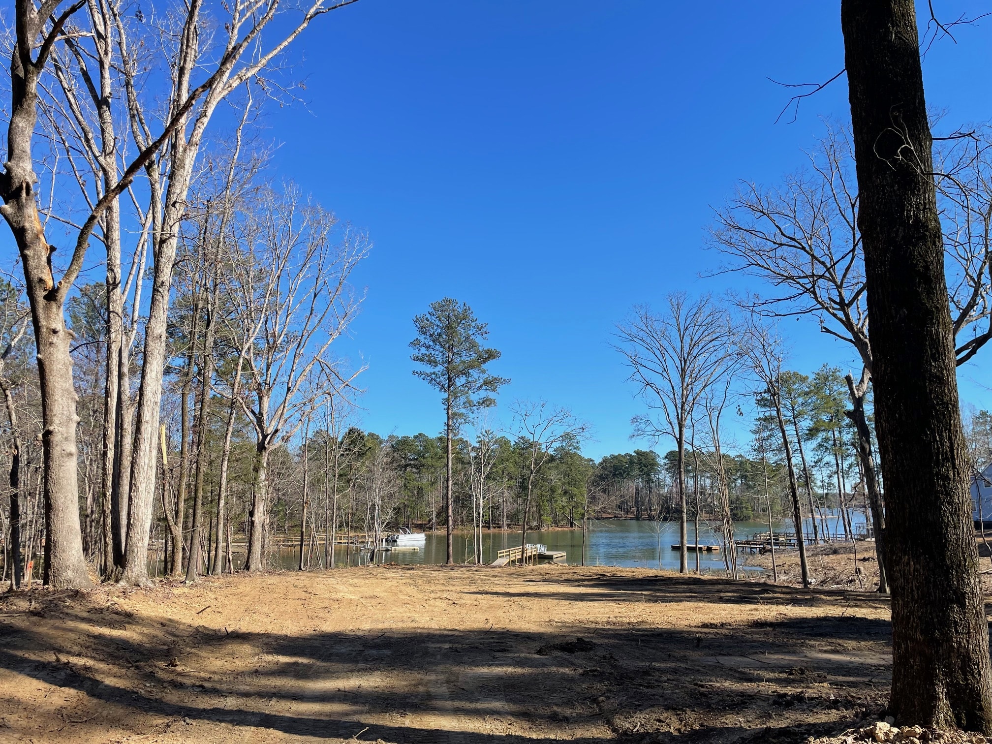 Two bulldozers on a red dirt construction site